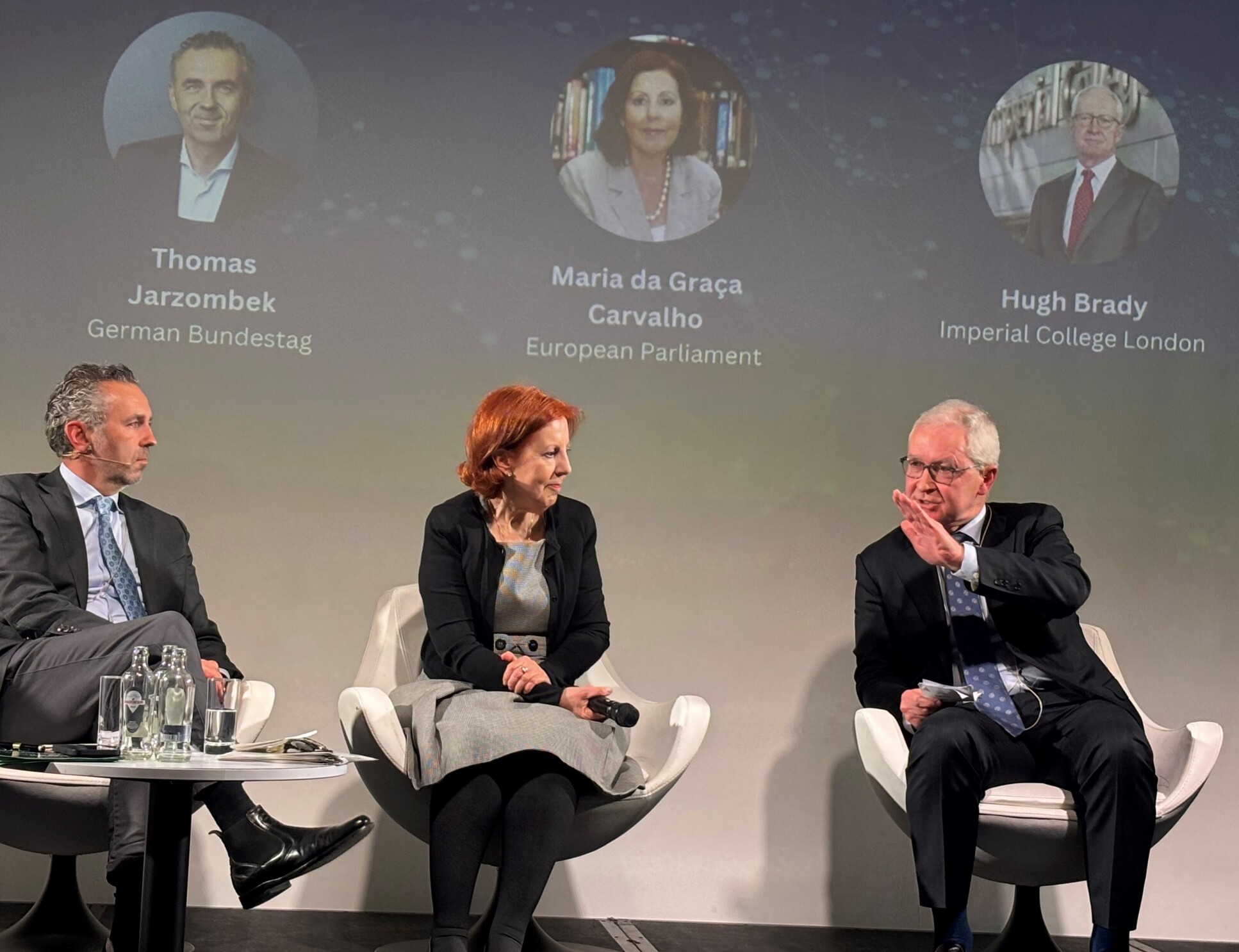 Professor Hugh Brady seated on a stage talking during Science Business conference