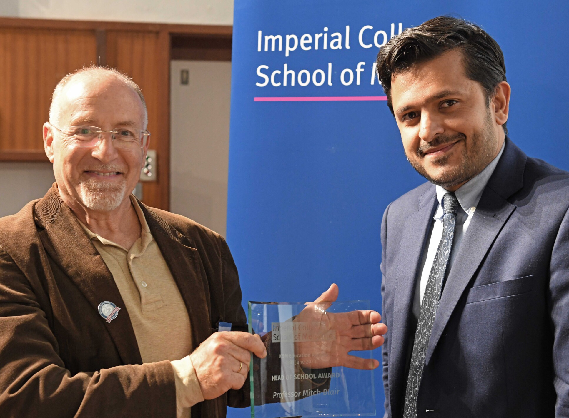 Professor Amir Sam presents Professor Mitch Blair with his award