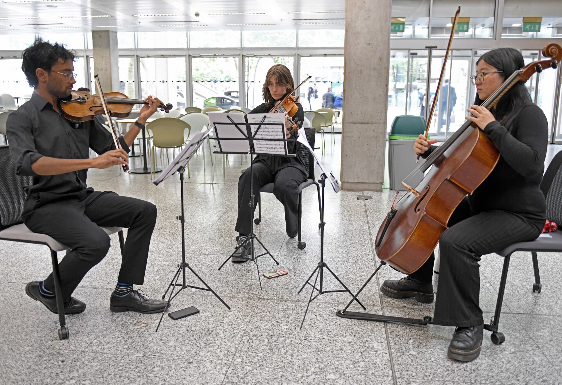 Student musicians Arjun Nurendran, Clara Canning-Jones and Ami Chen performed at the gathering after the ceremony