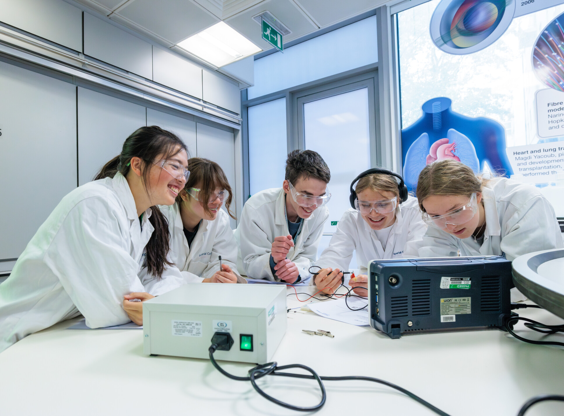 Students crowd round and look at a screen in the Out Reach Lab