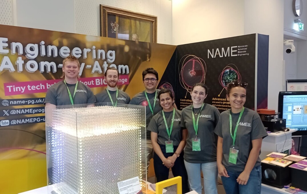 Some of the team pose in front of the exhibit