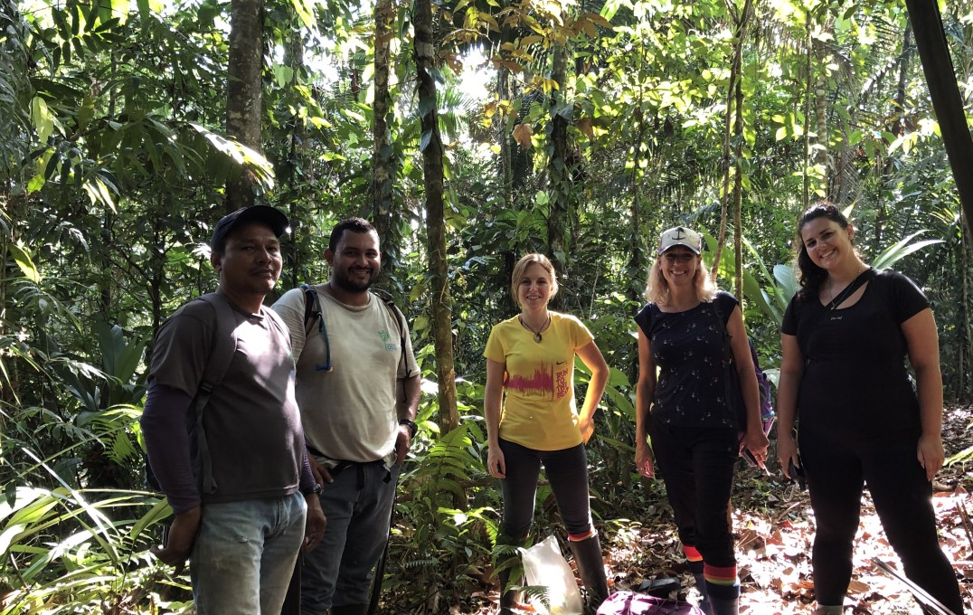 Group of people standing in the rainforest
