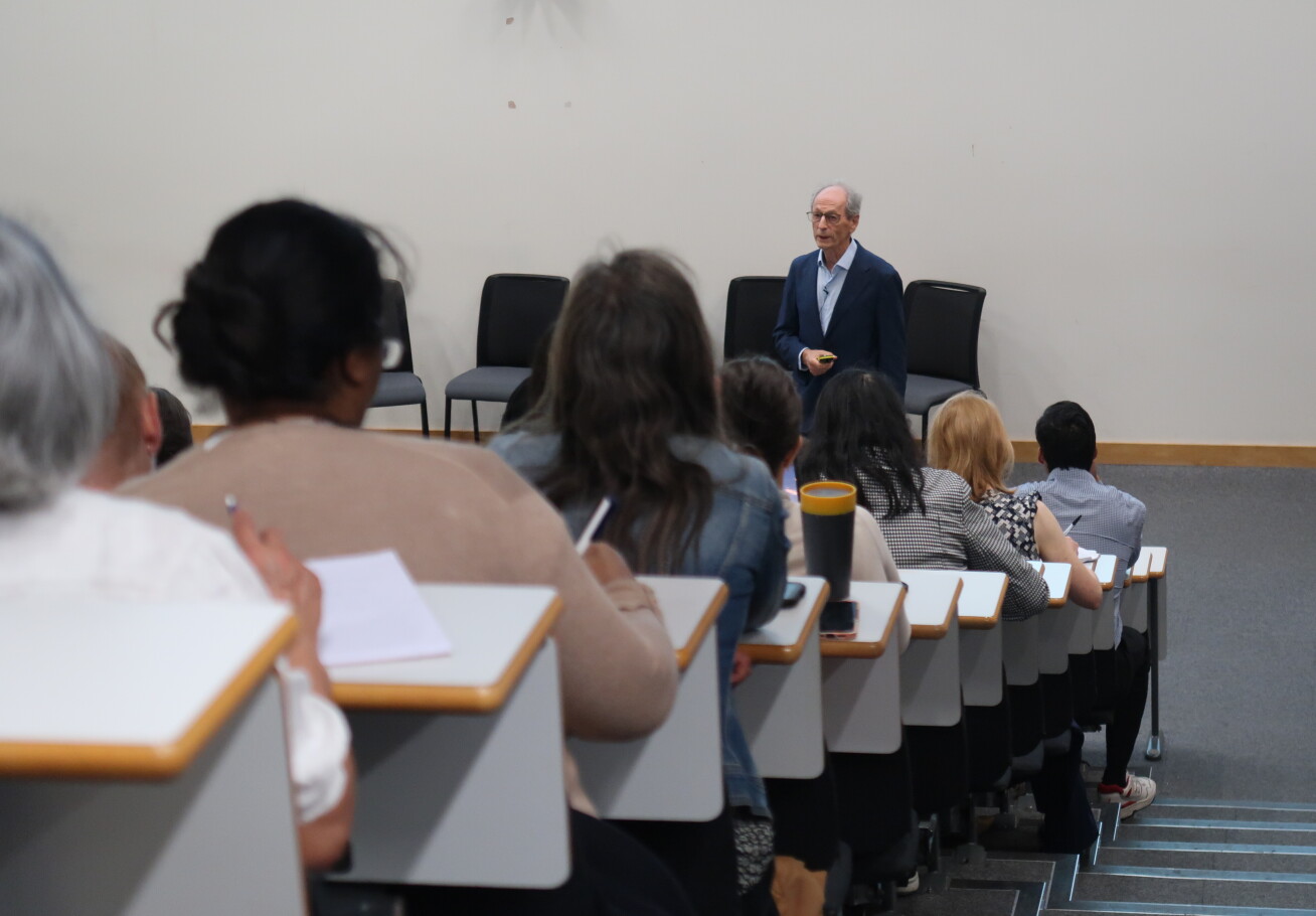 Presenter speaking to full lecture theatre