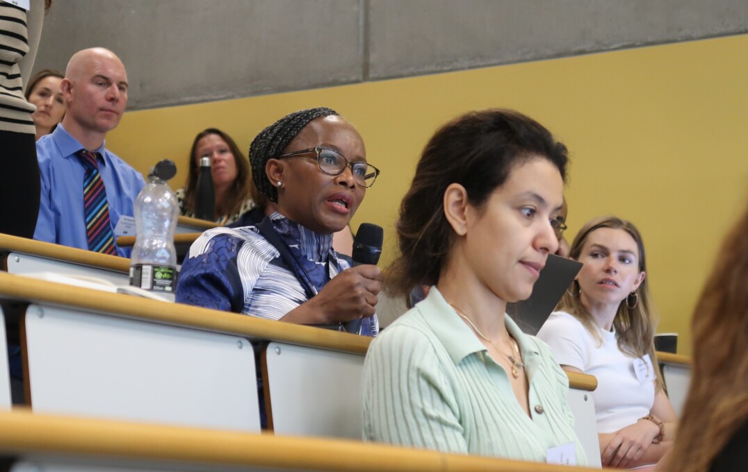 Audience in lecture theatre asking question into microphone