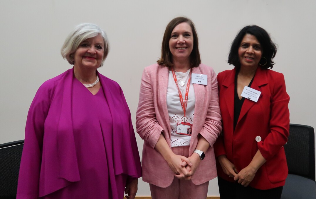 Three women stand together