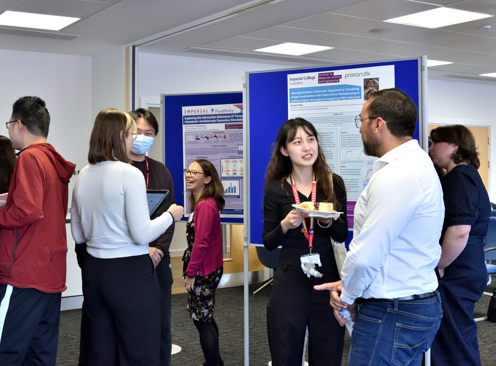 Attendees to IMSE's Research Showcase discussing students' posters.