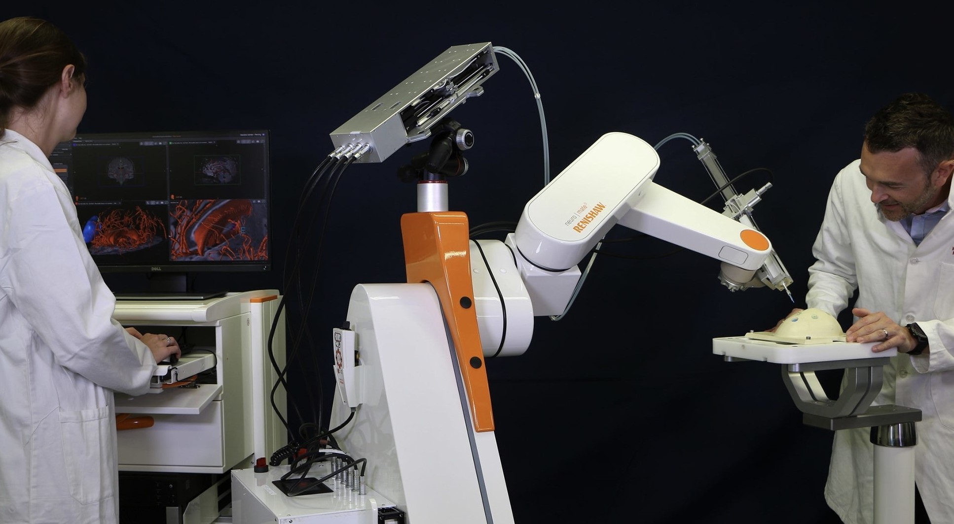 Photo showing the robotic arm setup. Left: the surgeon’s console with the visual interface. Right: the steerable catheter driver mounted onto the neurosurgical robot