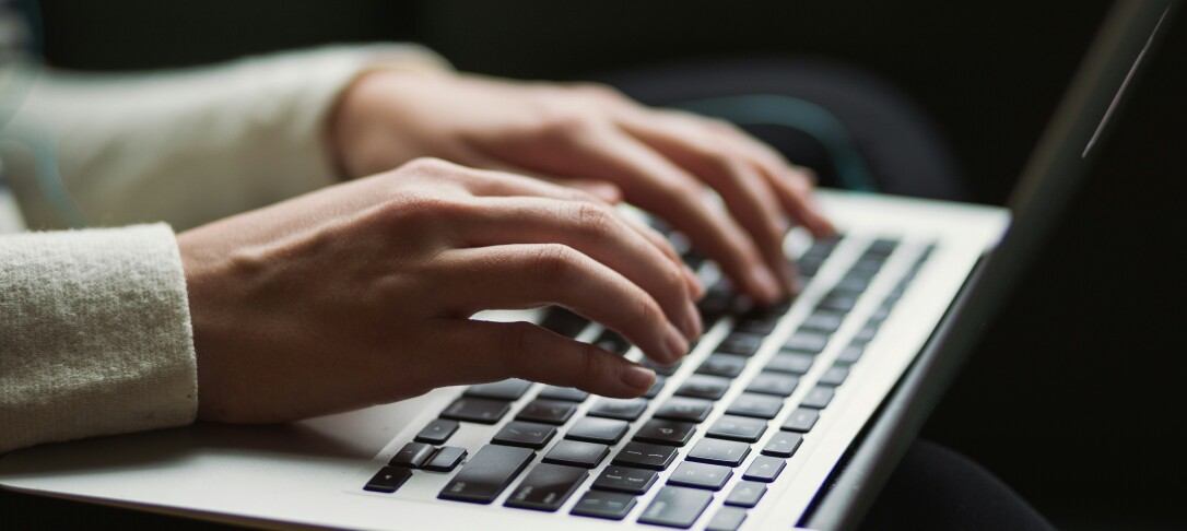 hands typing on laptop