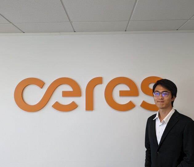 Masaki standing next to signage of the Ceres logo