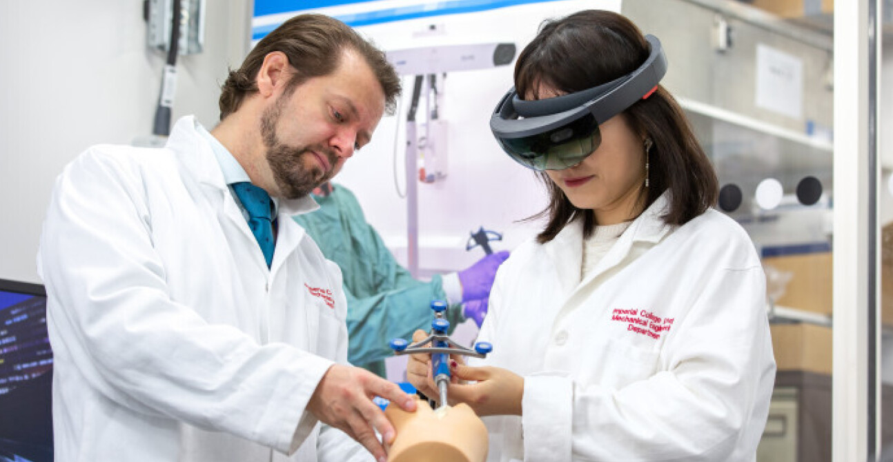 Student using medical tool while wearing a VR headset