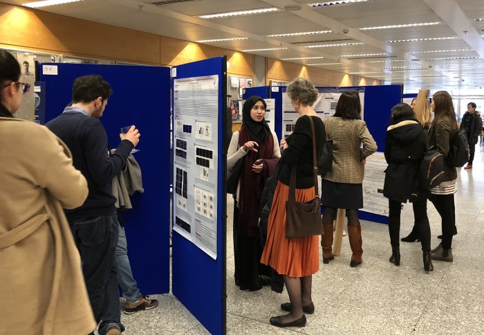 researchers look at posters