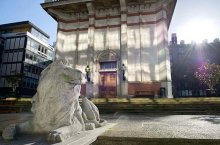 The stone lion at the base of the Queen's Tower