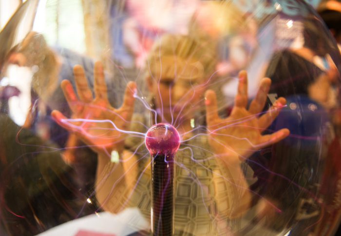 Photo of child putting hands on a plasma globe at last year's Exhibition