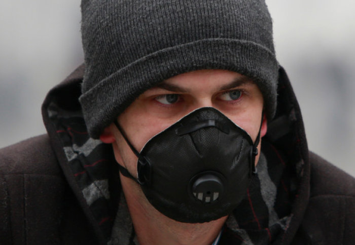 Pedestrian wearing a breathing mask