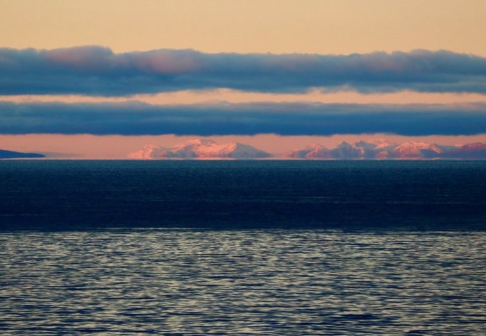 A view from a ship of the Southern Ocean - sea, icebergs, clouds