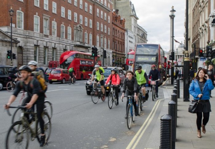 Commuters on London's roads in rush hour - cyclists, car drivers, bus drivers and pedestrians