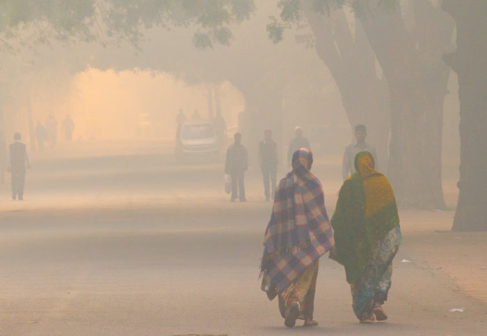New Delhi, India - November 12, 2012. Daily street life in the early morning during extreme smog conditions.
