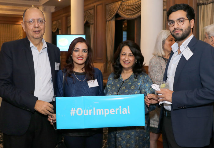 Imperial alumni with Nicola Pogson, Director of Alumni Relations, holding a banner that says we are Imperial alumni