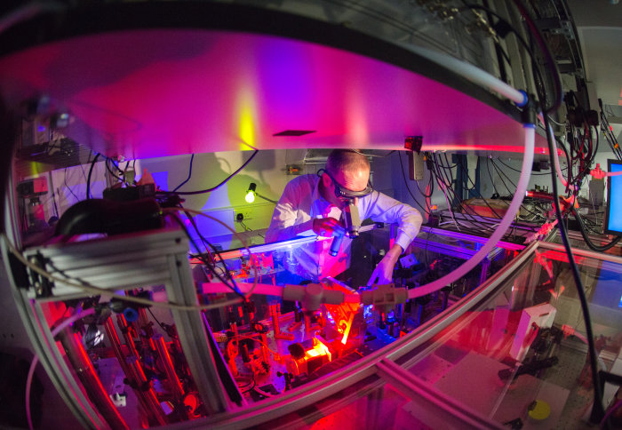 Man in protective gear working in ultrafast molecular imaging lab