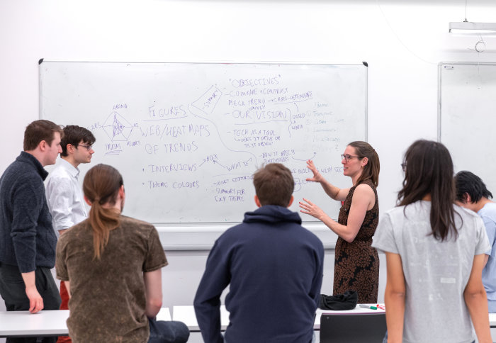 Students discuss using whiteboard