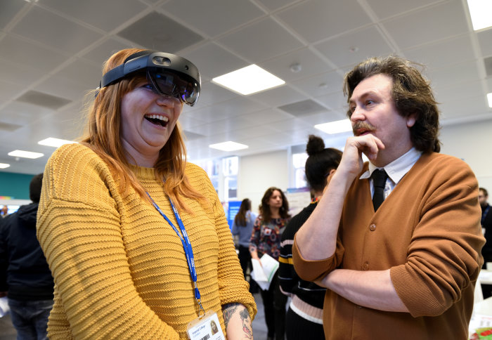 Man and woman try out Microsoft HoloLens2 augmented reality headset