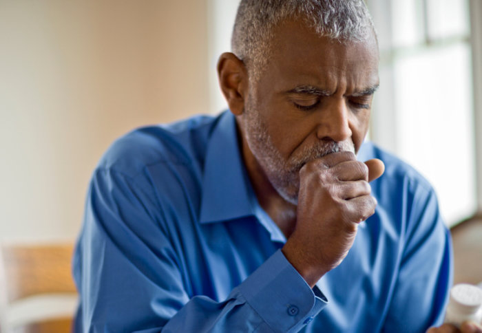 Older adult man coughing