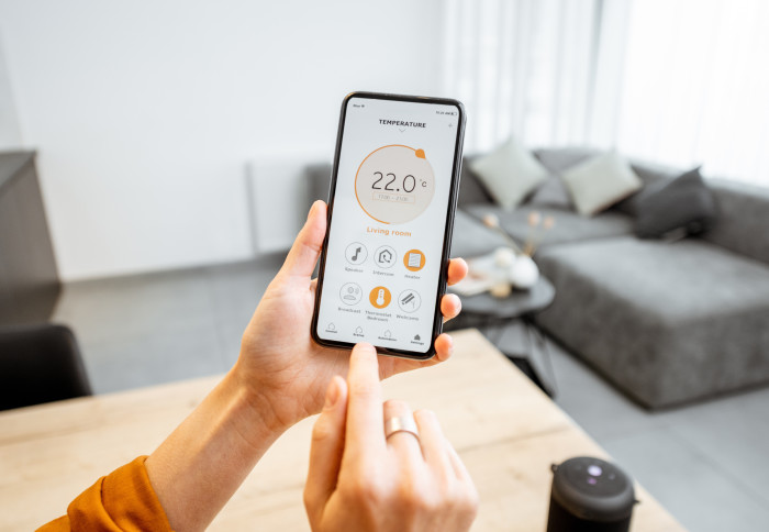 Smartphone showing temperature controls for living room