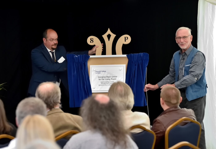 Two men unveiling plaque