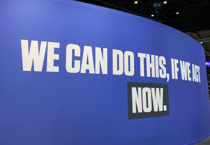 Words embossed on a wall at the COP26 conference centre read: "We can do this if we act NOW"