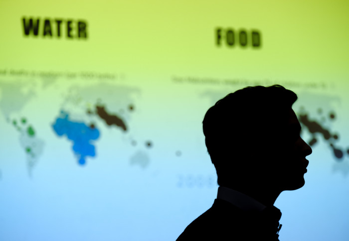 Image of a man's silhouette  against the background of a map with the labels food and water.