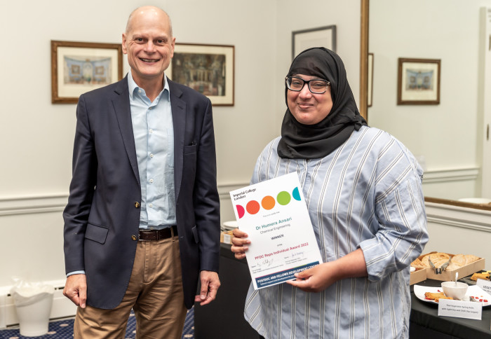 A woman receiving an award from a man