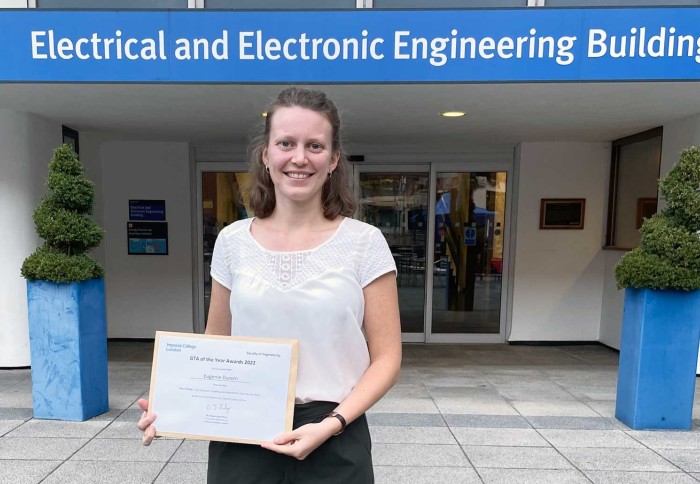 Eugenie with her certificate outside the EEE Building