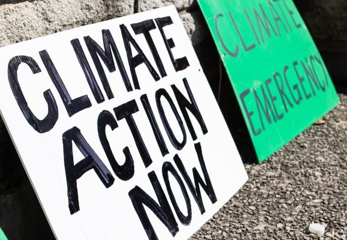 An image of a protest sign calling for action on climate change.