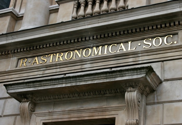 The outside of a building with R. Astronomical Soc. in gold lettering above the door