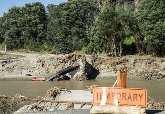 River with bridge destroyed by floodwaters.