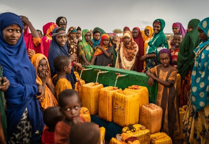 Women and children collect water in Baidoa, Somalia during the 2019 drough (Credit: Shutterstock)