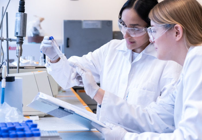 An image of two postgraduate students working in the lab