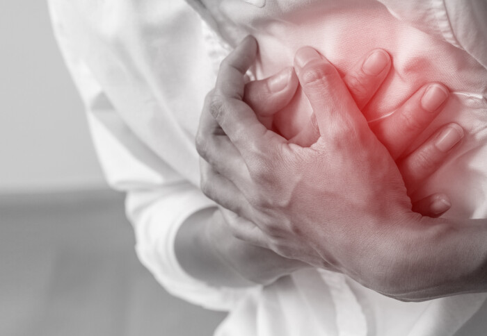 A black and white image of someone clutching hands to their chest