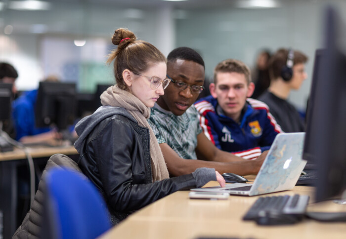 Students looking at laptop screen