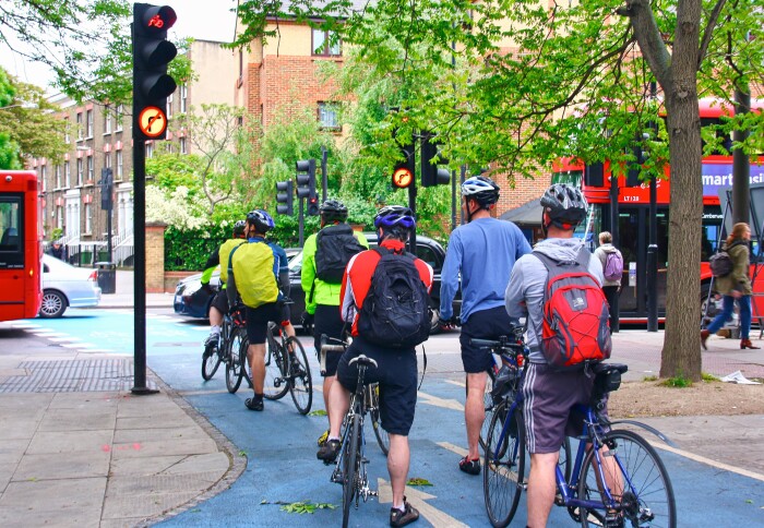 Cyclists wait at a traffic light in London.