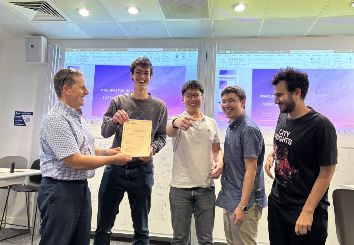 Dr Lee Shaw presents the ‘Award for Best Finite Element Simulation’ to MPT Coursework Group 3