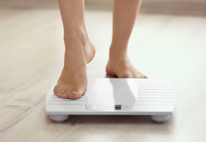Image of a person's foot stepping onto a scale