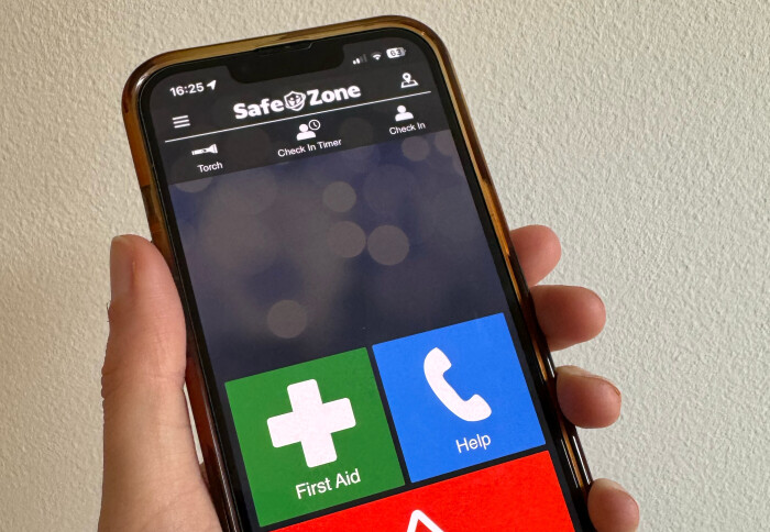 Phone in hand holding SafeZone App