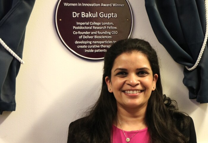Dr Bakul Gupta standing with her Purple Plaque at Imperial's Royal School of Mines.
