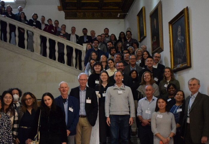 Meeting delegates assemble on the marble staircase of the Royal Society