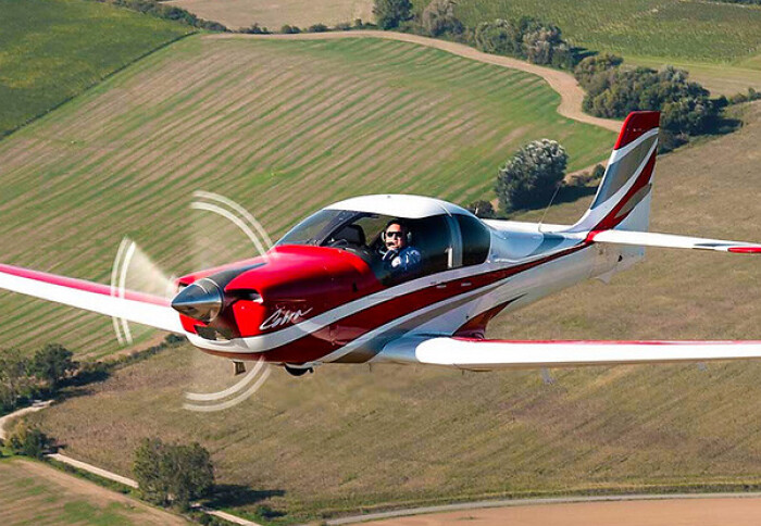 Evektor Super Cobra plane flying over fields