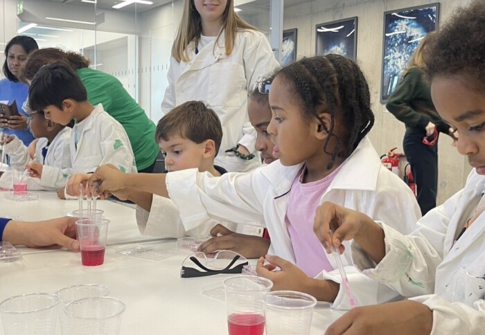 Children taking part in science experiments, using pipettes