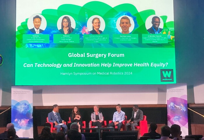 Panel of people sit on stage for Global Surgery Forum