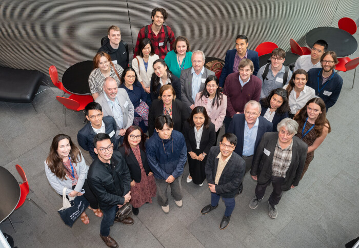 A group of people looking up at the camera and smiling