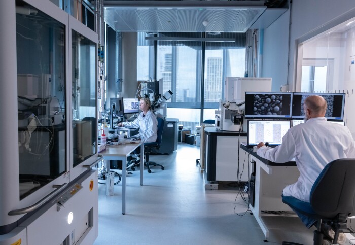 An image of two people using microscopy facilities in the laboratory at White City.
